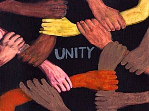This image shows a group of diverse people with interlocked hand in demonstration of Christian unity.